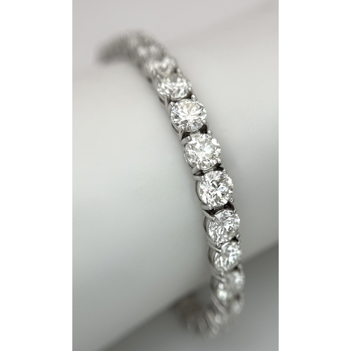 A W.G.I Certified 18K White Gold and 13.10ctw Diamond Tennis Bracelet. Round brilliant cut diamonds having I-J colour and SI1-2 clarity. 17cm length. 11.34g total weight. Ref: 22/936006.