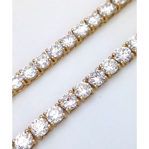 51 - A W.G.I Certified 10K Yellow Gold and Lab Diamond Tennis Necklace. 114 round brilliant cut diamonds ... 