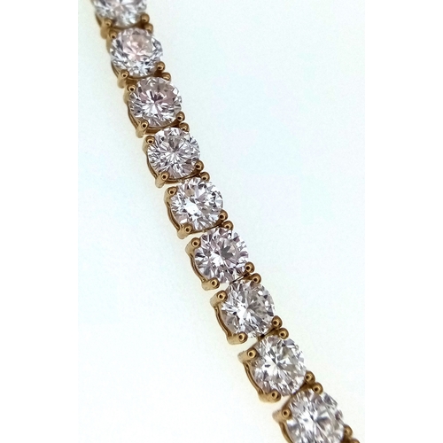 51 - A W.G.I Certified 10K Yellow Gold and Lab Diamond Tennis Necklace. 114 round brilliant cut diamonds ... 