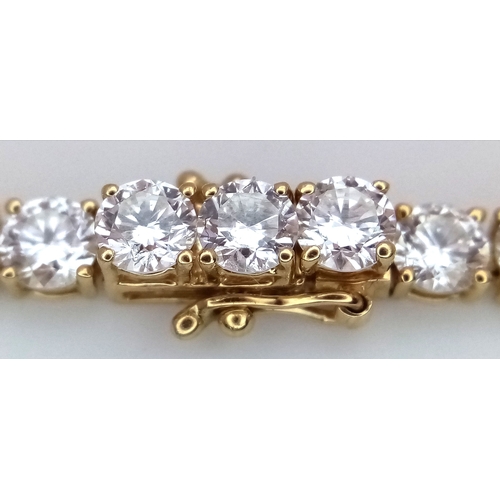 51 - A W.G.I Certified 10K Yellow Gold and Lab Diamond Tennis Necklace. 114 round brilliant cut diamonds ... 