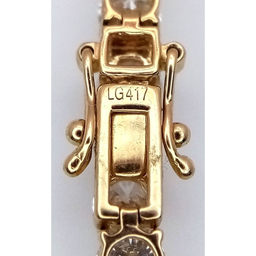 51 - A W.G.I Certified 10K Yellow Gold and Lab Diamond Tennis Necklace. 114 round brilliant cut diamonds ... 