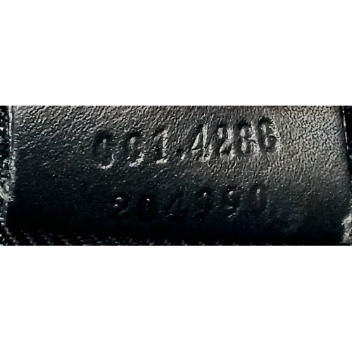 75 - A Black Gucci GG Canvas Shoulder Bag. Black GG monogram canvas exterior with gold-tone hardware, a s... 