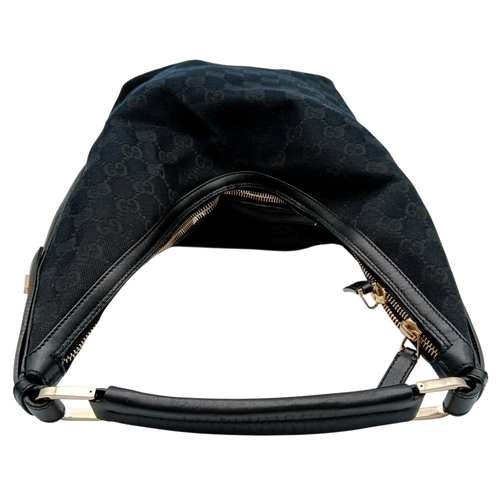 75 - A Black Gucci GG Canvas Shoulder Bag. Black GG monogram canvas exterior with gold-tone hardware, a s... 