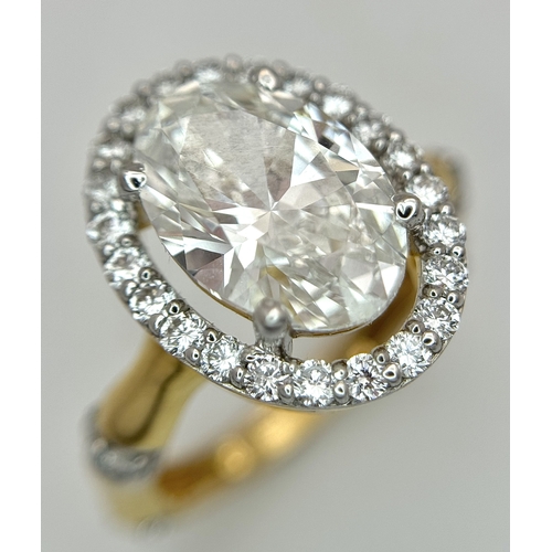 A W.G.I Certified 14K Yellow Gold and Lab Diamond Cocktail Ring. A 3.07ct oval cut centre stone having E colour and VVS2 clarity. 31 round brilliant cut diamond surround and accents. Size L 1/2. 4.02g total weight. Ref: 14/86006.