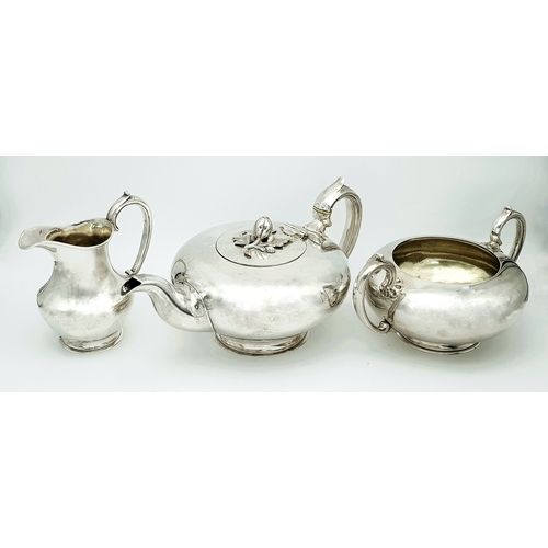 A BEAUTIFUL ENGLISH STERLING SILVER TEA SET MADE IN LONDON IN 1843 WEIGHING 1.2kgs THE LOW ROUNDED SHAPE IS CLASSIC 19th CENTURY AND FEATURES A CRAFTED FRUIT AND LEAF FINIAL AND COMING WITH A SUGAR BOWL AND CREAMER ALL IN GENERALLY GOOD CONDITION(THE TEAPOT HAS A COUPLE OF VERY SMALL DENTS FROM USE)