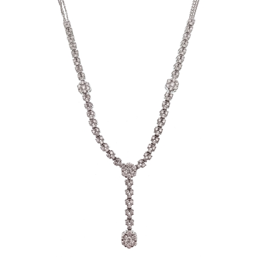 An 18K White Gold Diamond Necklace. Set with round brilliant cut diamonds in a graduated articulated design with a central drop pendant, the diamonds having a total estimated weight of approximately 3.00 carats. Necklace measures 44cm in length with a 3cm drop. Gross weight 14.14g.