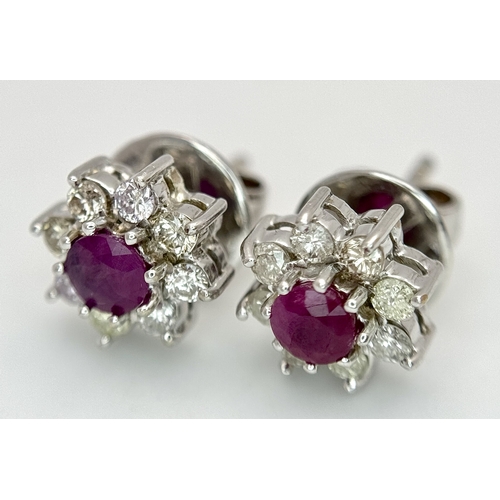 A PAIR OF 18K WHITE GOLD RUBY AND DIAMOND CLUSTER EARRINGS . 3.6gms