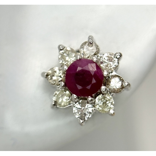 A PAIR OF 18K WHITE GOLD RUBY AND DIAMOND CLUSTER EARRINGS . 3.6gms