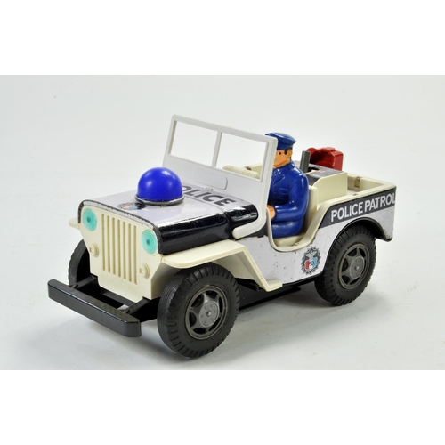 1192 - Japanese battery operated tinplate Police Jeep. Working example is generally good to very good.