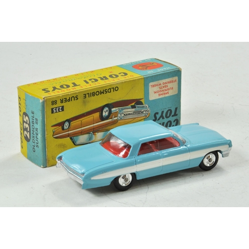 1595 - Corgi No. 235 Oldsmobile Super 88.  Light blue body with red interior. White side stripe flash. Spun... 