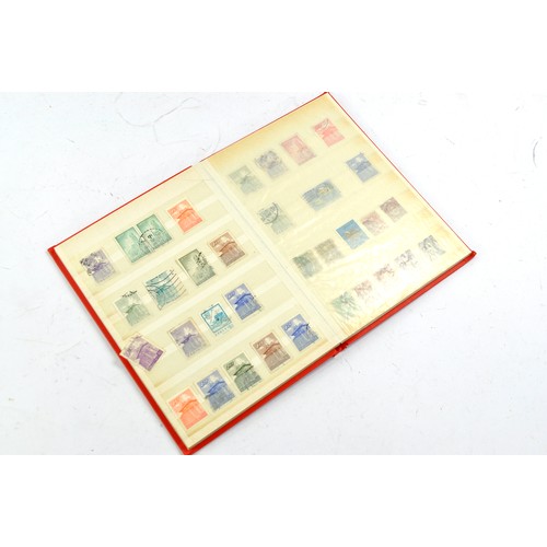 1506 - Stamps comprising a small album of Japanese issues, mid 20th century.