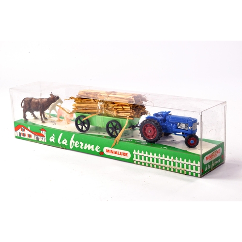 217 - Minialuxe (made in France) plastic farm set comprising Fordson Tractor and trailer plus animals. Exc... 