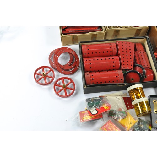 556 - Assorted Meccano parts and components including some original earlier issues as shown.