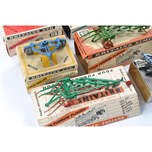 79 - A group of 7 Boxed Britains Farm Vintage Implement issues all in fair boxes but items very good to e... 