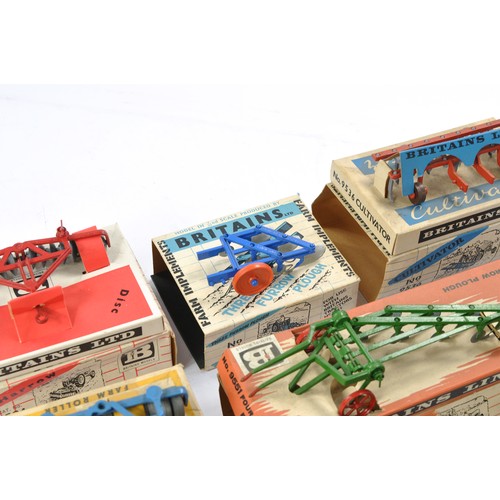 79 - A group of 7 Boxed Britains Farm Vintage Implement issues all in fair boxes but items very good to e... 