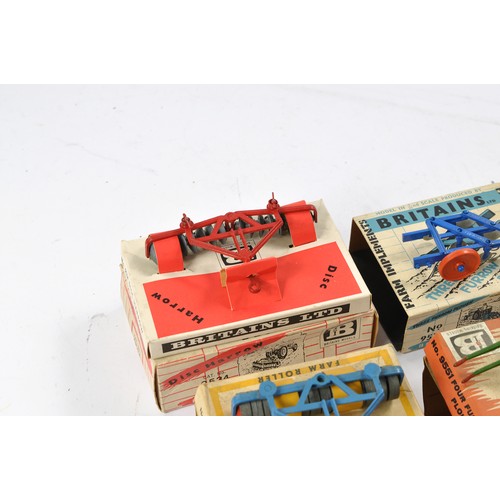 79 - A group of 7 Boxed Britains Farm Vintage Implement issues all in fair boxes but items very good to e... 