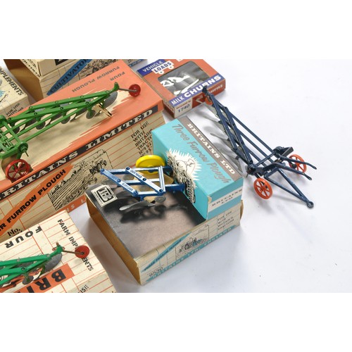 79 - A group of 7 Boxed Britains Farm Vintage Implement issues all in fair boxes but items very good to e... 