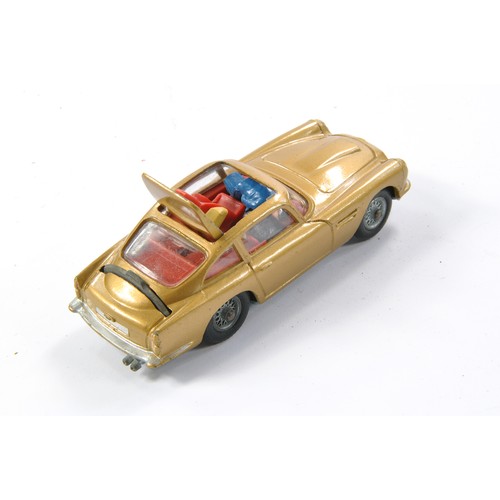 407 - Corgi No. 261 James Bond 007 Aston Martin DB5. Gloss 'Toffee' Gold with red interior and Light Tan e... 