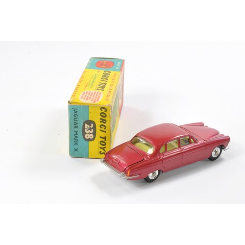 488 - Corgi No. 238 Jaguar Mark X. Metallic cerise with lemon interior. Generally excellent with no obviou... 