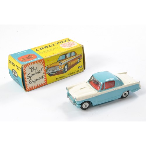 512 - Corgi No. 231 Triumph Herald coupe. White and blue with red interior. Very good to excellent with th... 