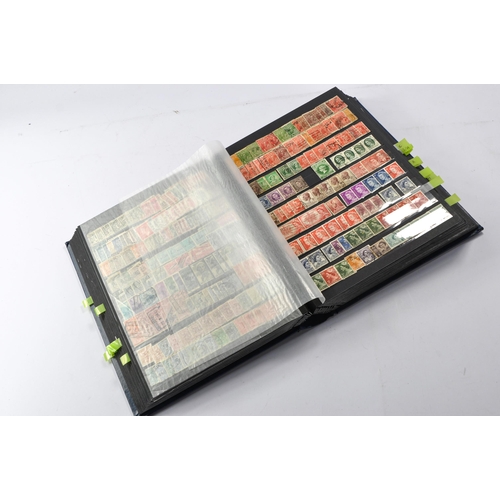 652 - Stamps, a large worldwide stamp album comprising used and unused issues dating throughout the 20th c... 