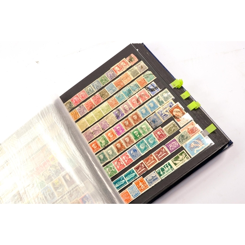 652 - Stamps, a large worldwide stamp album comprising used and unused issues dating throughout the 20th c... 