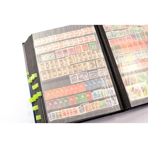 652 - Stamps, a large worldwide stamp album comprising used and unused issues dating throughout the 20th c... 