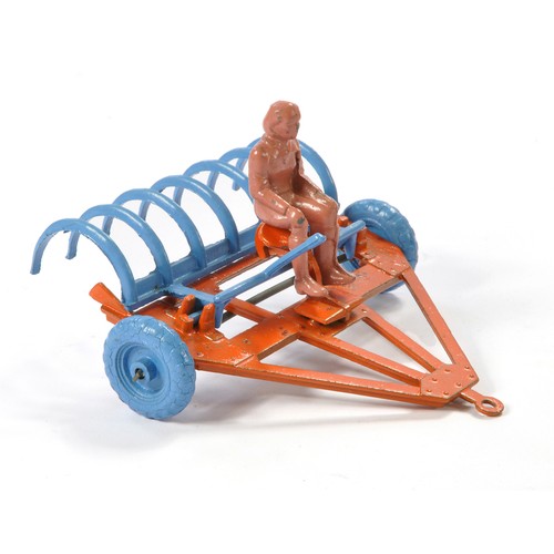 103 - Moko Hay-Rake comprising original rake in orange with blue tines and wheels. Lever mechanism lifts t... 