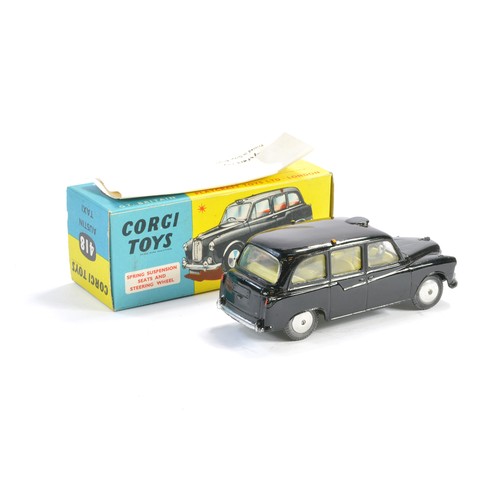 217 - Corgi No. 418 Austin Taxi. Black with lemon interior. Excellent with very little sign of wear in exc... 