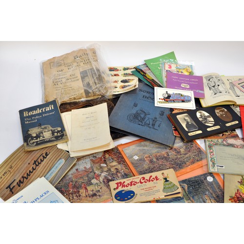 215 - A large collective group of paraphernalia, ephemera and vintage bygones. Puzzles, manuals, royal int... 