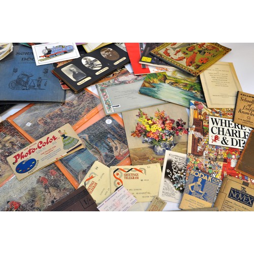 215 - A large collective group of paraphernalia, ephemera and vintage bygones. Puzzles, manuals, royal int... 