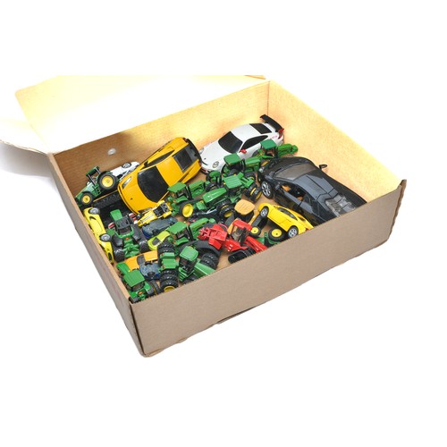 153 - A group of mostly 1/64 diecast Model Tractor issues from Ertl, to include mainly John Deere themes. ... 