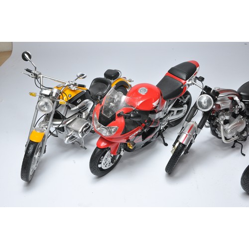 193 - Four 1/6 New Ray (or similar) plastic and diecast motorcycles as shown. BMW, Ducatti, Honda and Triu... 