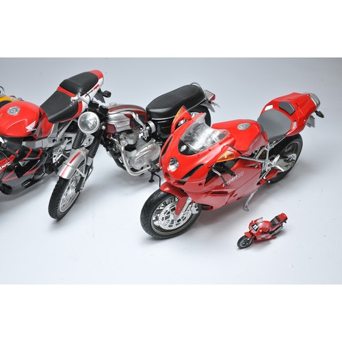 193 - Four 1/6 New Ray (or similar) plastic and diecast motorcycles as shown. BMW, Ducatti, Honda and Triu... 