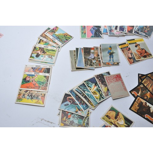 430 - A collection of vintage trading cards featuring issues for Superman, Batman, Captain Scarlet, Thunde... 