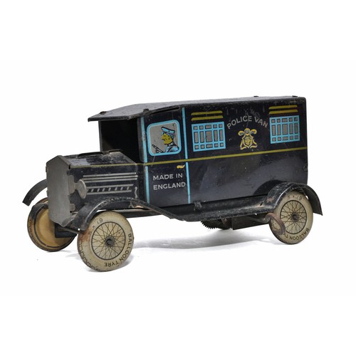 1132 - Wells clockwork tinplate Police Van. Dark blue with litho print. In working order. Generally good bu... 