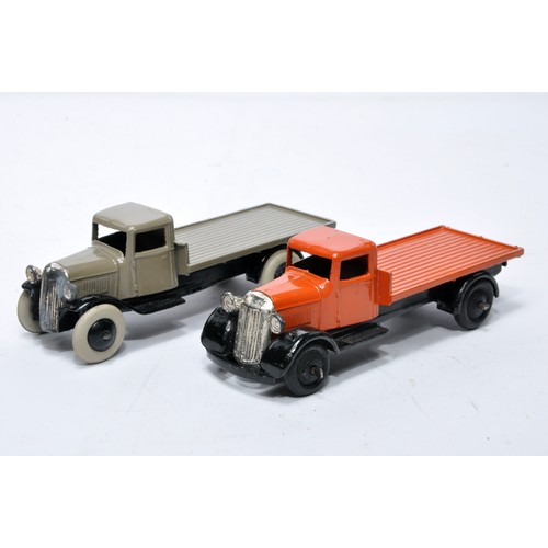 624 - Dinky No. 25c flatbed truck. Duo of issues in orange and fawn grey as shown (note baseplate variatio... 