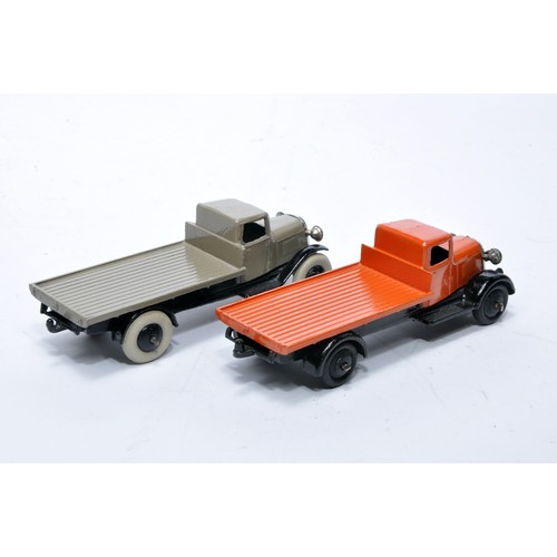 624 - Dinky No. 25c flatbed truck. Duo of issues in orange and fawn grey as shown (note baseplate variatio... 