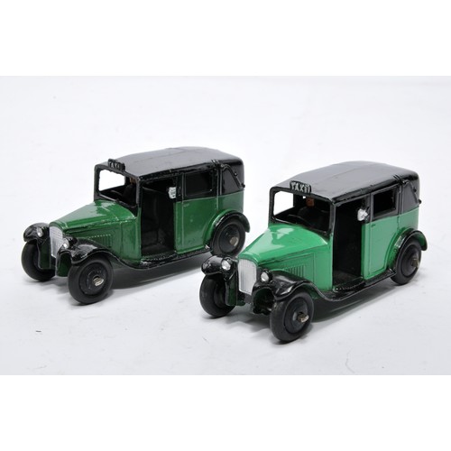 693 - Dinky No. 36g Taxi. Duo of issues in green as shown (note shade variation). Both display generally v... 