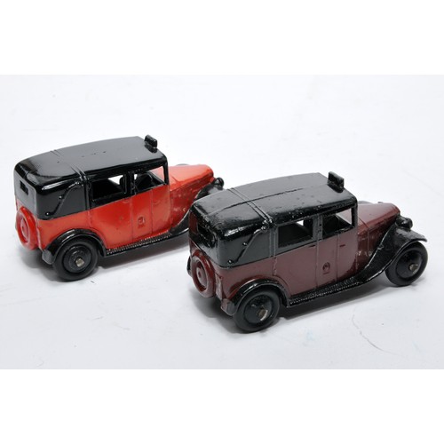 694 - Dinky No. 36g Taxi. Duo of issues in red and maroon as shown. Both display generally very good to ex... 