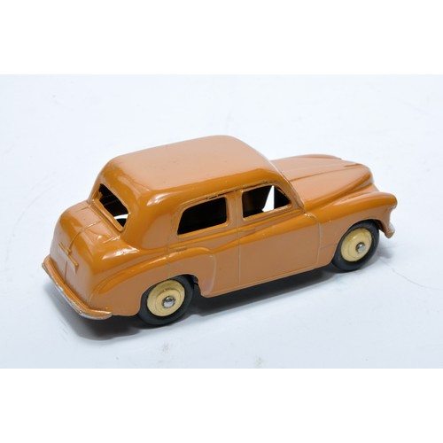 796 - Dinky No. 154 Hillman Minx Saloon. Single issue is in dark tan, with cream hubs, as shown. Displays ... 