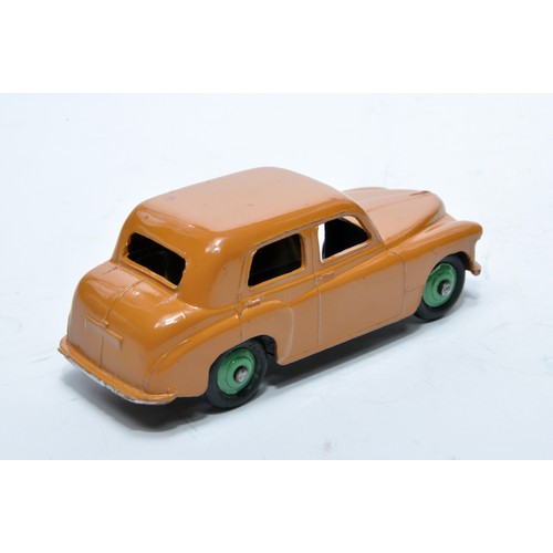 797 - Dinky No. 154 Hillman Minx Saloon. Single issue is in dark tan, with green hubs, as shown. Displays ... 