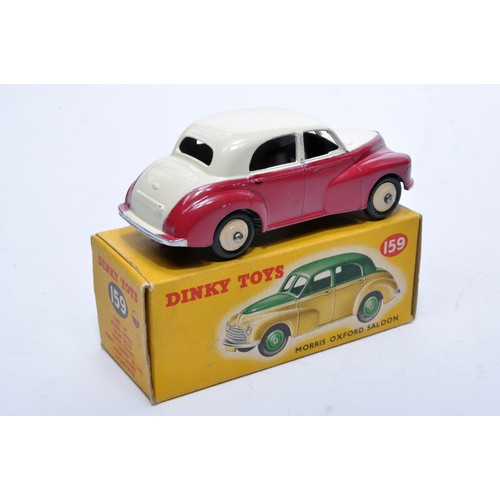 824 - Dinky No. 159 Morris Oxford. Single issue is in two-tone off-white and cerise, with cream hubs, as s... 