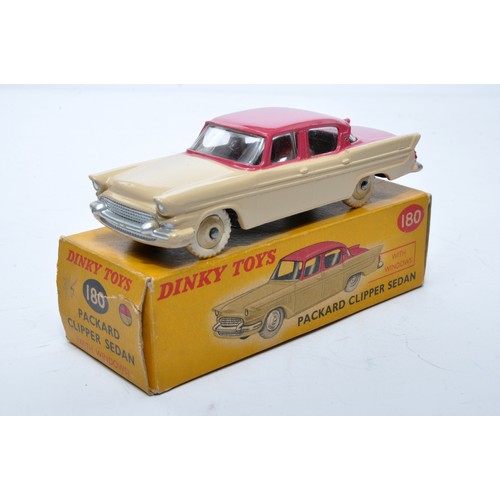 869 - Dinky No. 180 Packard Clipper Sedan. Single issue is in two-tone cerise and peach, with peach hubs, ... 