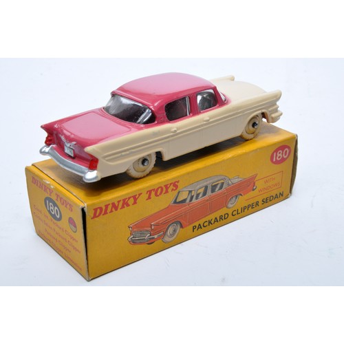 869 - Dinky No. 180 Packard Clipper Sedan. Single issue is in two-tone cerise and peach, with peach hubs, ... 