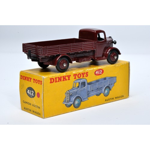 963 - Dinky No. 412 Austin Open Back Wagon. Single issue is in maroon with maroon hubs, as shown. Displays... 