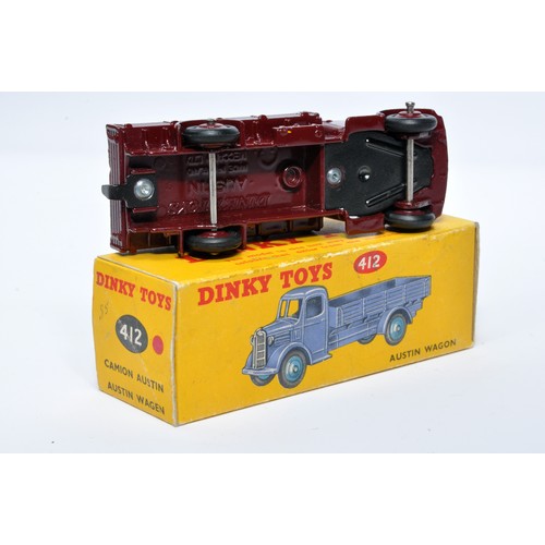 963 - Dinky No. 412 Austin Open Back Wagon. Single issue is in maroon with maroon hubs, as shown. Displays... 