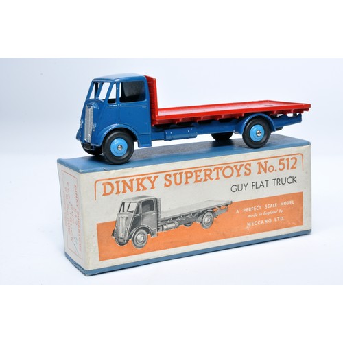 1032 - Dinky No. 512 Guy flat truck. Single issue is in red and blue, with mid-blue hubs, as shown. Display... 