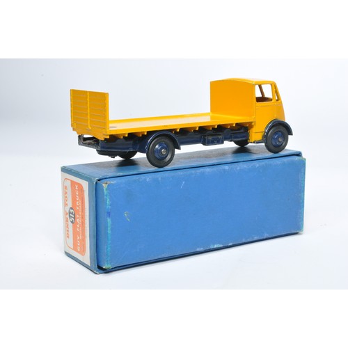 1034 - Dinky No. 513 Guy flat truck with tailboard. Single issue is in yellow / dark blue, with dark blue h... 