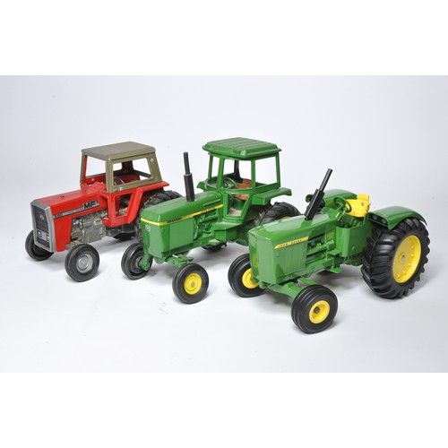 61 - A trio of 1/16 diecast model farm tractors including John Deere and Massey Ferguson issues from Ertl... 